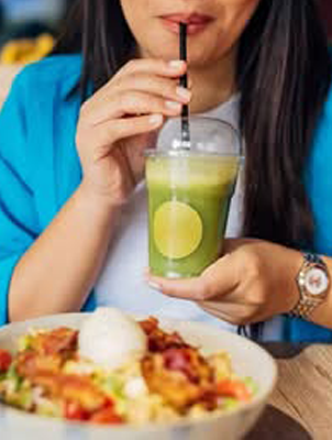 Woman holding orange slice, representing tooth enamel protection